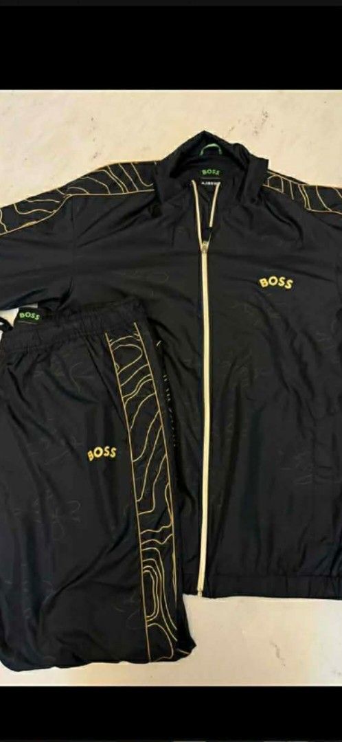 BOSS Tracksuit Black and Gold (Category: Sets & Coordinates) located in General Trias. Submitted by qwerty2015 (Listing ID 1414511484, Image 1). Description: - BOSS tracksuit set - Includes zip-up jacket and matching pants - Features gold accents - BOSS logo present - Lightweight material - Jacket has a collar - Pants have a drawstring.