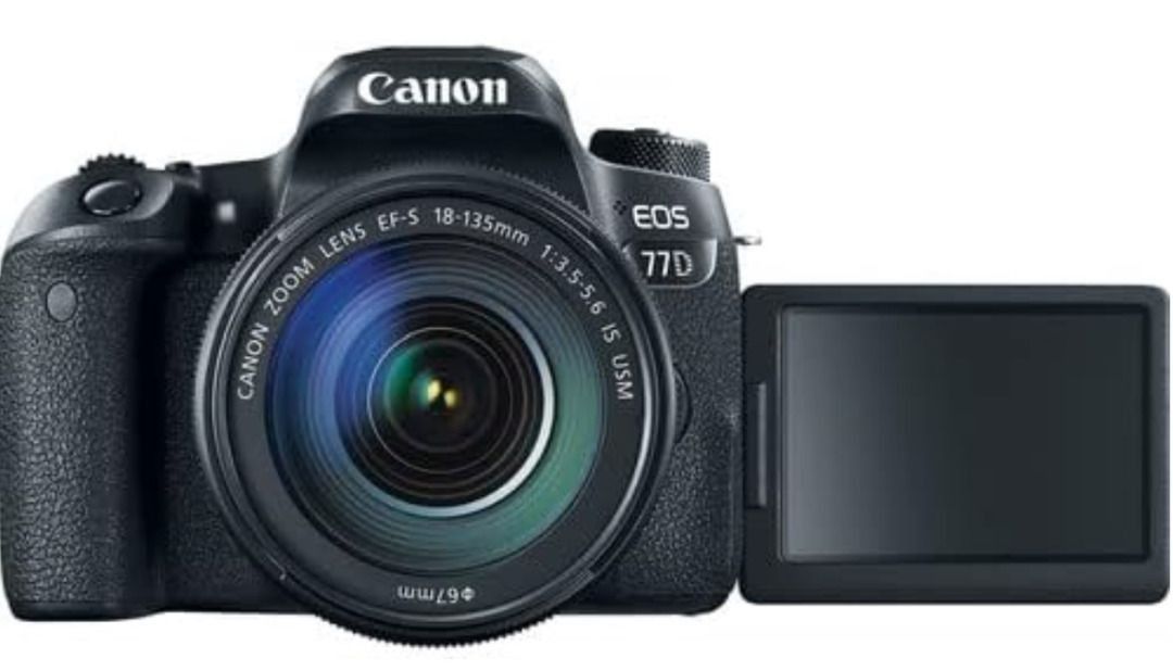 Canon EOS 77D EF-S 18-135 IS USM Kit (Category: Cameras) located in Pasig City. Submitted by carou07274 (Listing ID 1414481186, Image 2). Description: Canon EOS 77D camera with EF-S 18-135 IS USM lens kit. Features a 24.2MP CMOS sensor, 45 AF points, and Dual Pixel CMOS AF. Includes Wi-Fi and NFC capabilities. The camera has a rear LCD screen and various control buttons. The lens has image stabilization. Full Box+ accessoiries /lightly use 99% li