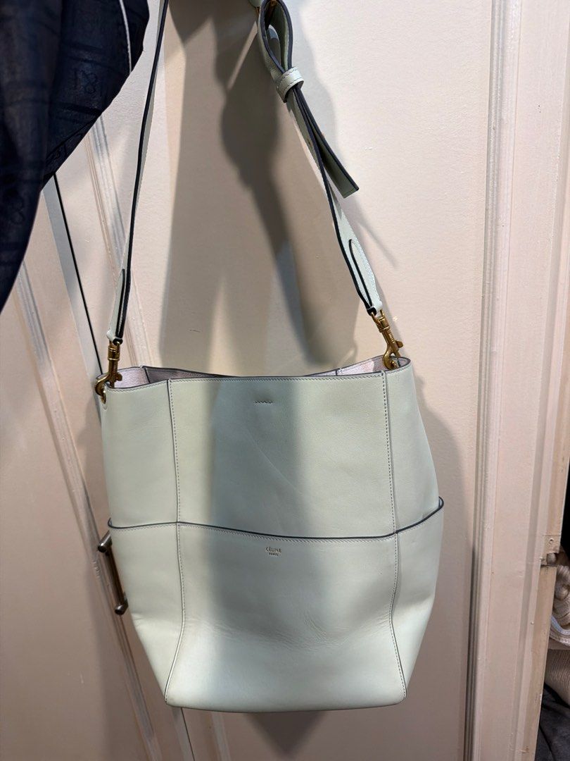 Rush sale Celine Bucket Bag (Category: Luxury Bags & Wallets) located in Quezon City. Submitted by branded_closet01 (Listing ID 1414591077, Image 1). Description: - Celine bucket bag - Light green color - Made of leather - Spacious interior with multiple pockets - Includes shoulder strap - Magnetic closure - Celine logo visible inside RUSH SALE .