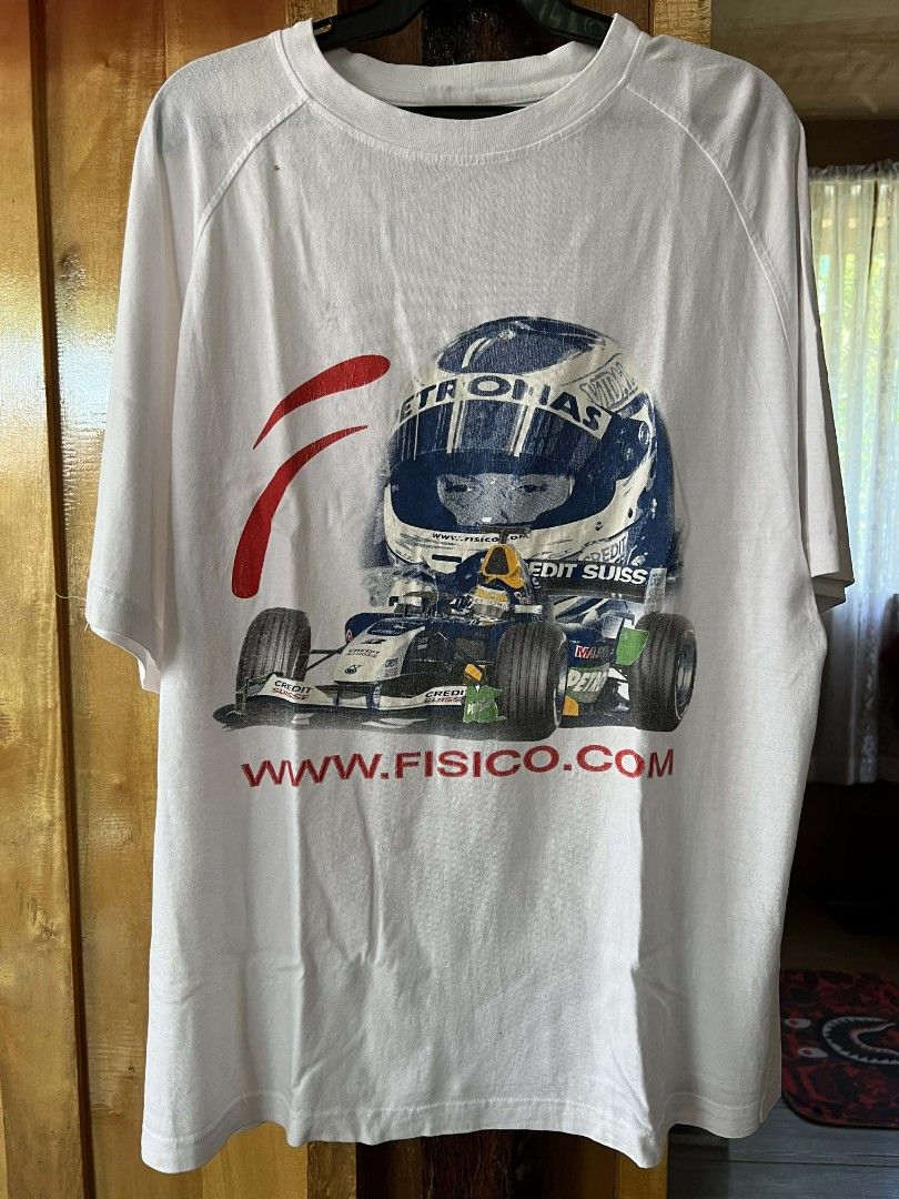 Fisico Formula 1 Racing T-shirt (Category: Tshirts & Polo Shirts ) located in Manila. Submitted by galitsacorrupt (Listing ID 1414484524, Image 1). Description: - White t-shirt featuring an F1 racing car and driver helmet graphic. - Includes "PETRONAS" and "CREDIT SUISSE" branding. - Features "www.FISICO.com " website print. - Condition: Shows wear with a small hole and some stains..