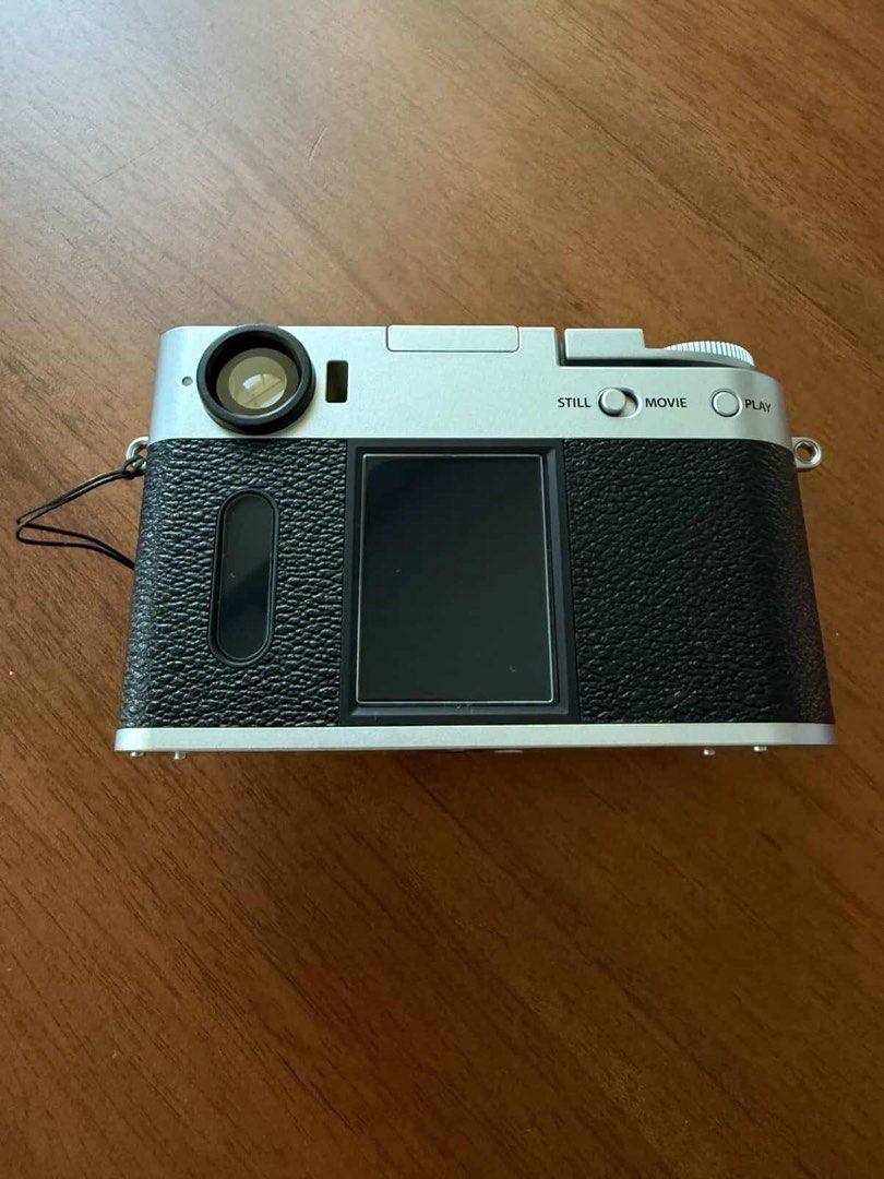 Fujifilm X-half Camera (Category: Cameras) located in Quezon City. Submitted by stealfinds_mnl (Listing ID 1414512400, Image 3). Description: Includes box as if newly bought, used literally twice haha - Fujifilm X-half camera - Silver and black body - Includes lens cap and strap - Features: - Screen - Buttons for stills, movies, and playback - Top dial - Fujifilm logo.