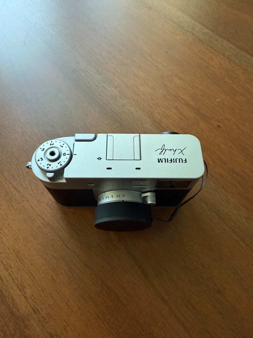 Fujifilm X-half Camera (Category: Cameras) located in Quezon City. Submitted by stealfinds_mnl (Listing ID 1414512400, Image 2). Description: Includes box as if newly bought, used literally twice haha - Fujifilm X-half camera - Silver and black body - Includes lens cap and strap - Features: - Screen - Buttons for stills, movies, and playback - Top dial - Fujifilm logo.