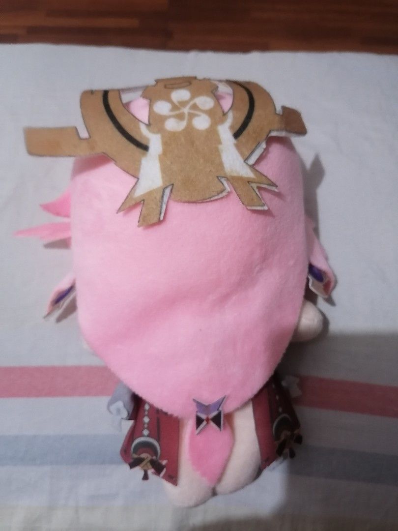 Genshin Impact Yae Miko Plush (Category: Plushies & Soft Toys) located in Pasig City. Submitted by phantasmnyx (Listing ID 1414621993, Image 2). Description: - Yae Miko plushie from Genshin Impact. - Features pink hair and purple eyes. - Detailed outfit with a white top and red accents. - Includes headpiece detail on the back. - Perfect for Genshin Impact fans and collectors..