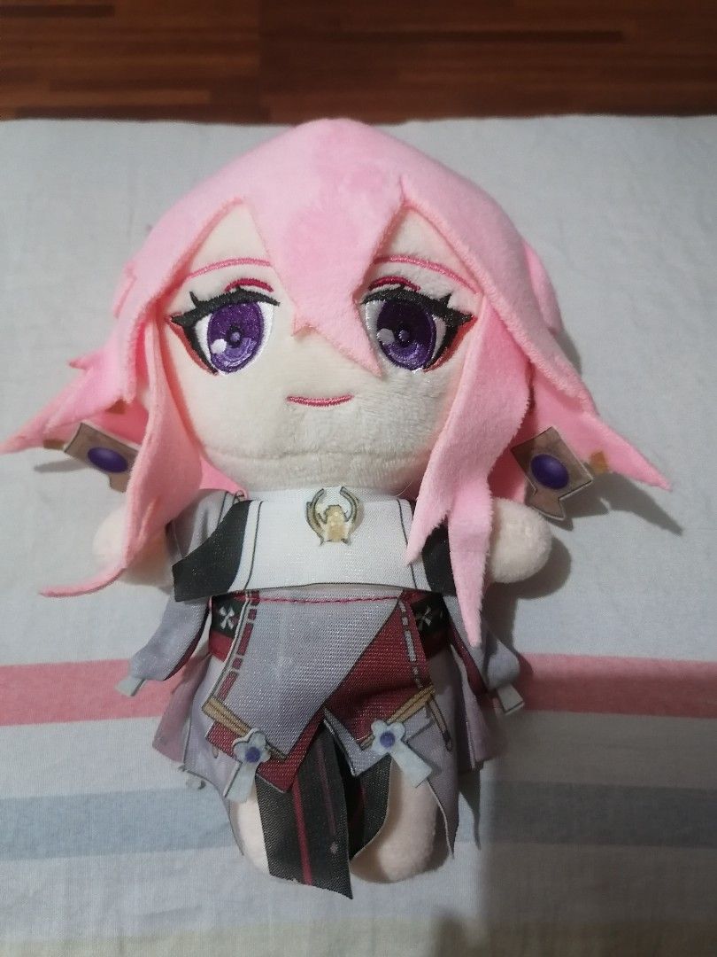 Genshin Impact Yae Miko Plush (Category: Plushies & Soft Toys) located in Pasig City. Submitted by phantasmnyx (Listing ID 1414621993, Image 1). Description: - Yae Miko plushie from Genshin Impact. - Features pink hair and purple eyes. - Detailed outfit with a white top and red accents. - Includes headpiece detail on the back. - Perfect for Genshin Impact fans and collectors..