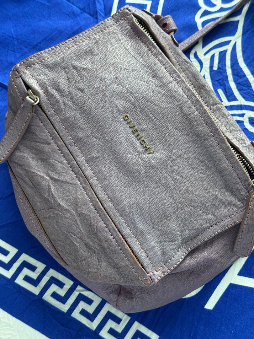 Givenchy Pandora Shoulder Bag (Category: Luxury Bags & Wallets) located in Mandaue City. Submitted by melbafelis47966 (Listing ID 1414507973, Image 2). Description: - Authentic Givenchy Pandora shoulder bag - Color: Lavender - Features: - Top zip closure - Front zip pocket - Shoulder strap - Interior: - Givenchy label - "Made in Italy" tag (ES 0910) - Givenchy logo on front.