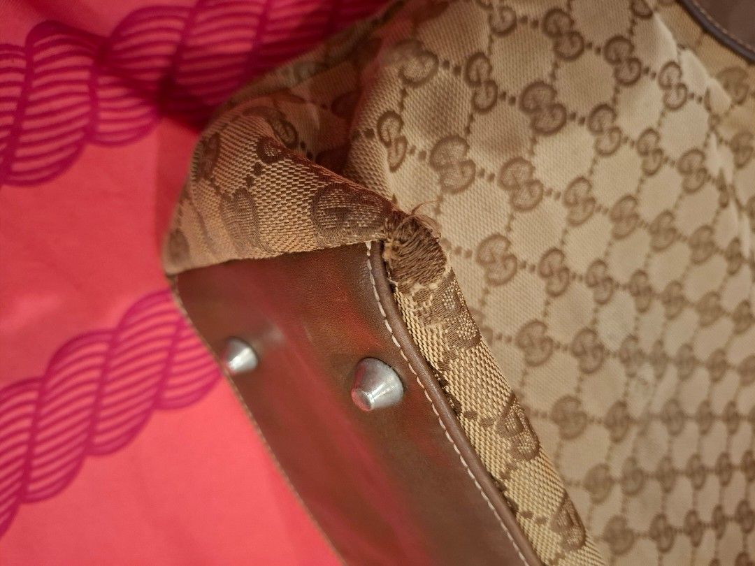 Gucci GG Canvas Tote Bag (Category: Luxury Bags & Wallets) located in Manila. Submitted by warmcat-ee9368 (Listing ID 1414579303, Image 3). Description: - Authentic Gucci tote bag - Iconic GG canvas pattern - Brown leather accents - Braided handle - Light brown fabric lining - Includes Gucci leather tag - Made in Italy - Minor wear on one corner.