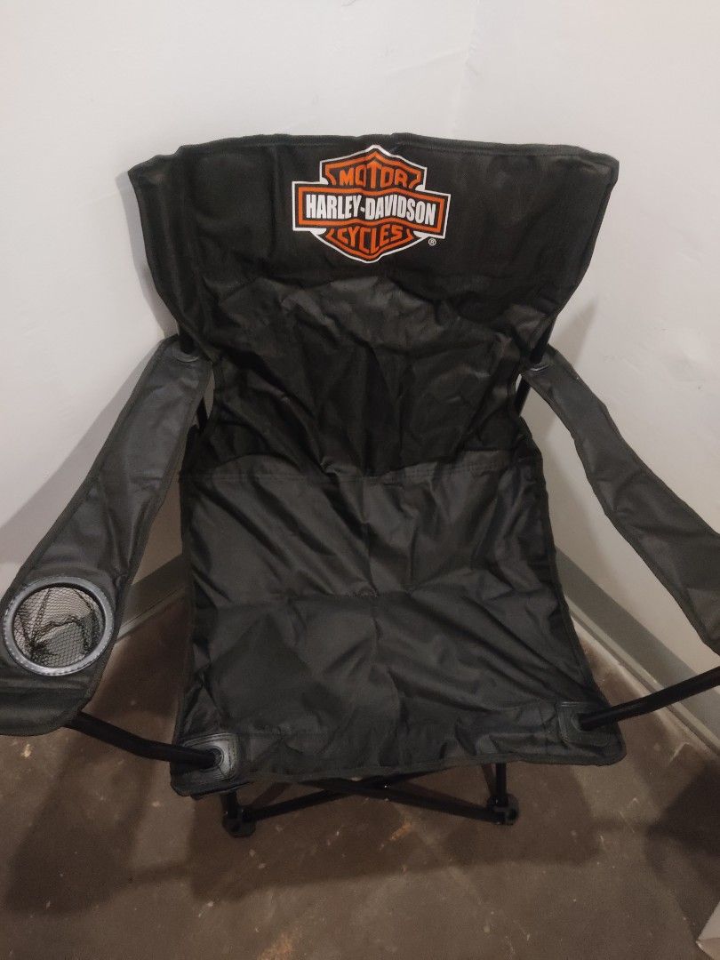 Harley-Davidson Folding Camping Chair w/ Storage Bag (Category: Chairs) located in Caloocan City. Submitted by skyhigh0919 (Listing ID 1414607349, Image 3). Description: - Black Harley-Davidson folding camping chair - Features armrests and a built-in cup holder - Includes a carrying bag with the Harley-Davidson logo - Folds up for easy storage and transport - Ideal for outdoor events and relaxation -contact # 09388429469 ( slightly negotiable ).