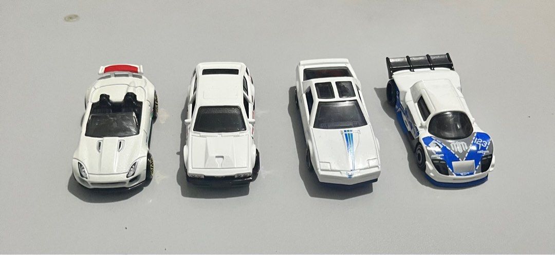 Hot Wheels “White Assorted Cars” (Mattel) (Category: Vehicle & Diecast Models) located in Quezon City. Submitted by pwrproductions (Listing ID 1414589580, Image 1). Description: Includes rare mad mike, pontiac firebird, Alfa Romeo and jaguar convertible (White)..