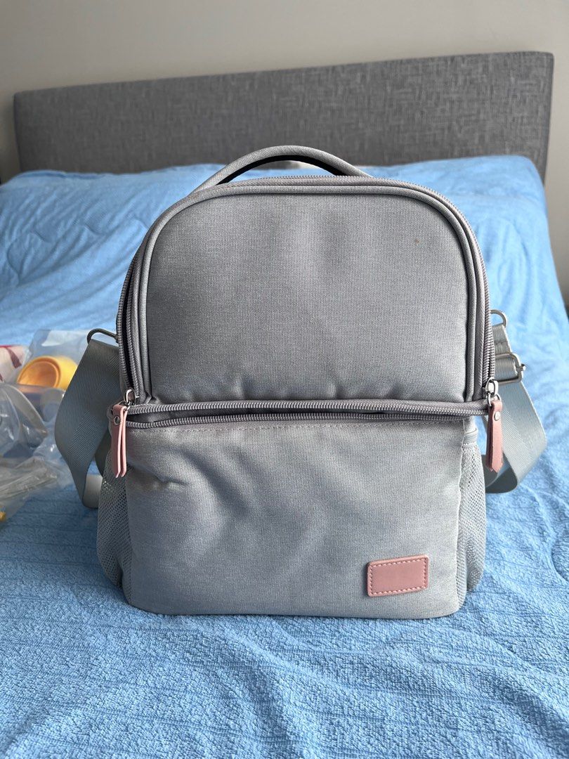 Insulated Breastmilk Bag (Category: Breastfeeding & Bottle Feeding) located in Taguig. Submitted by lonelyclothes (Listing ID 1414525963, Image 1). Description: Brand: Olive & Cloud Bought from babyhub for ₱1,999. Insulated bag can be used as a handbag, shoulder bag, or backpack. It has a top handle and a detachable shoulder strap. The bag has two compartments and a mesh pocket inside. Free: Buds & Blooms Breastfeeding Cleansing Mist..