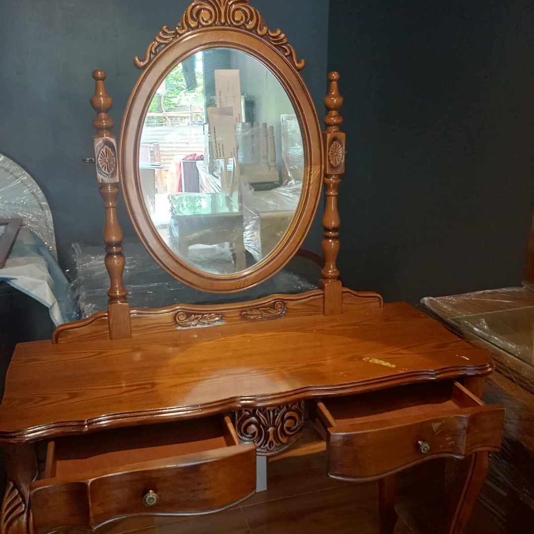 KOREAN SURPLUS Wooden Vanity Table with Oval Mirror (Category: Tables & Sets) located in Minglanilla. Submitted by naquilagretchen (Listing ID 1414482496, Image 2). Description: - Wooden vanity table - Oval mirror - Two drawers for storage - Ornate carvings - Warm, polished finish - Decorative mirror posts - Gracefully curved legs.