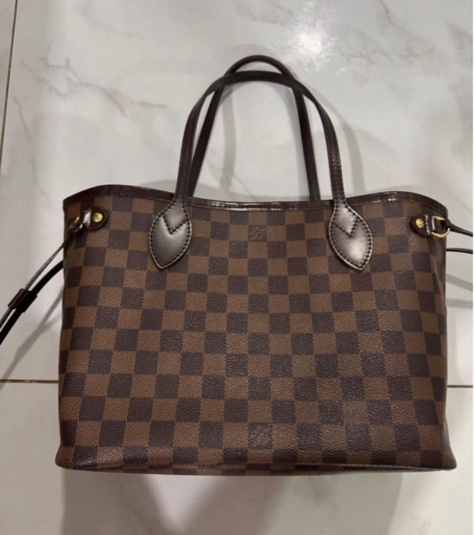 Louis Vuitton Damier Ebene Neverfull MM (Category: Luxury Bags & Wallets) located in Manila. Submitted by decluterthings888 (Listing ID 1414604599, Image 3). Description: - Authentic Louis Vuitton Neverfull pm - Damier Ebene canvas - Brown leather handles and trim - Gold-tone hardware - Spacious interior - Adjustable side laces - Stylish everyday tote.