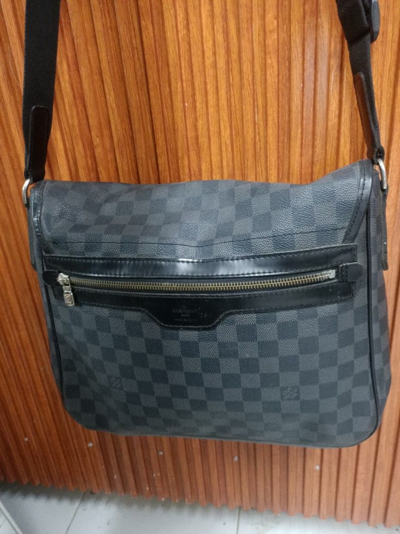 Louis Vuitton Damier Graphite Messenger Bag (Category: Luxury Bags & Wallets) located in Manila. Submitted by rheaaa00530 (Listing ID 1414557696, Image 1). Description: - Louis Vuitton Damier Graphite Messenger Bag - Features a zippered front pocket - Secure flap closure - Adjustable black shoulder strap - Leather trim - Iconic LV logo - Ideal for everyday wear.