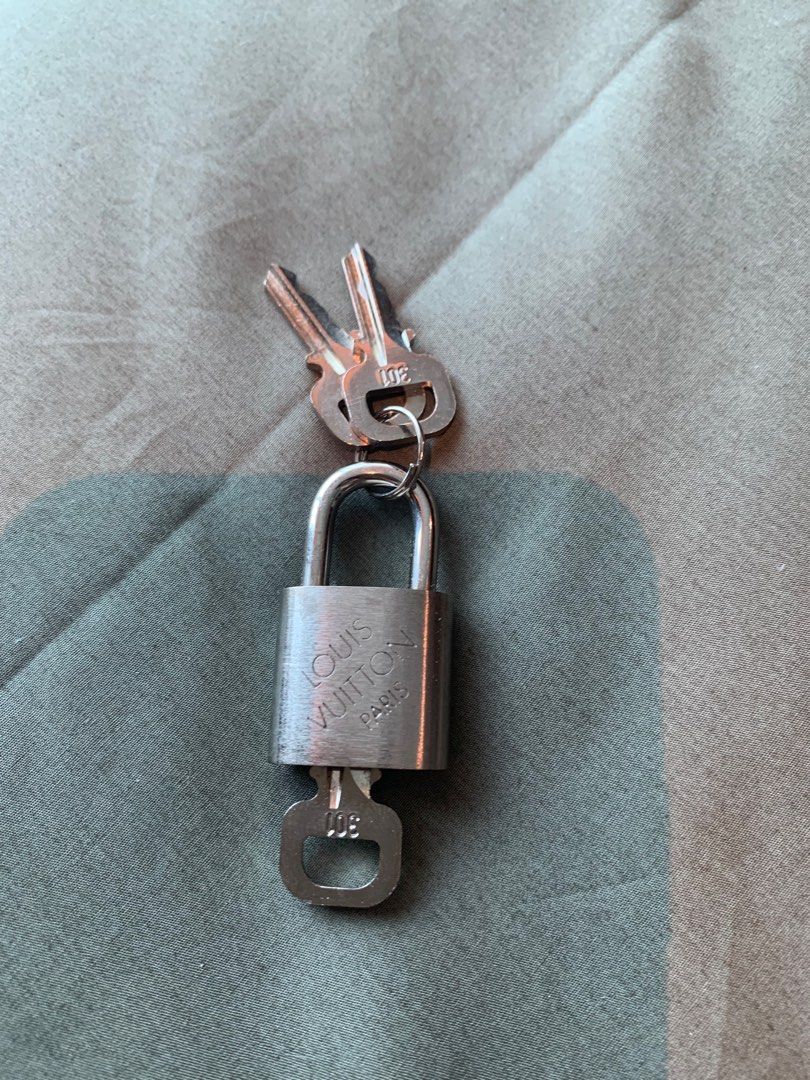 Louis Vuitton Padlock with Keys (Category: Luxury Bags & Wallets) located in Mandaluyong City. Submitted by envoguevintage88 (Listing ID 1414465800, Image 1). Description: - Authentic Louis Vuitton padlock - Includes two keys - Silver-toned finish - Features the Louis Vuitton Paris logo - Key ring included - Key numbers: 301 and 008 - Perfect for Louis Vuitton luggage and bags.