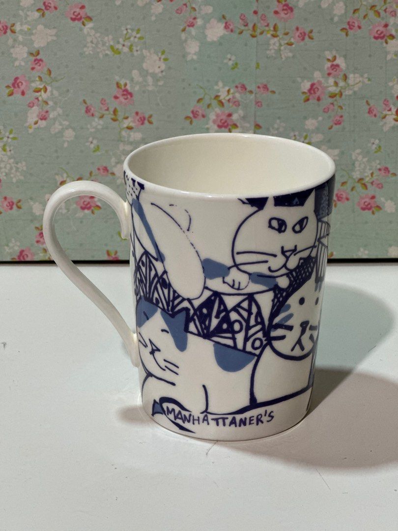 Manhattaner mug — white & blue cat design (Category: Coffee & Tea Tableware) located in Davao. Submitted by favoritepreloved (Listing ID 1414554557, Image 1). Description: Original Manhattaner ceramic mug featuring a charming white and blue cat design. Known for its artistic style and quality craftsmanship, Manhattaner mugs are popular among cat lovers and collectors. ❤️Features a blue and white cat illustration design. ❤️Made by Mikasa under the