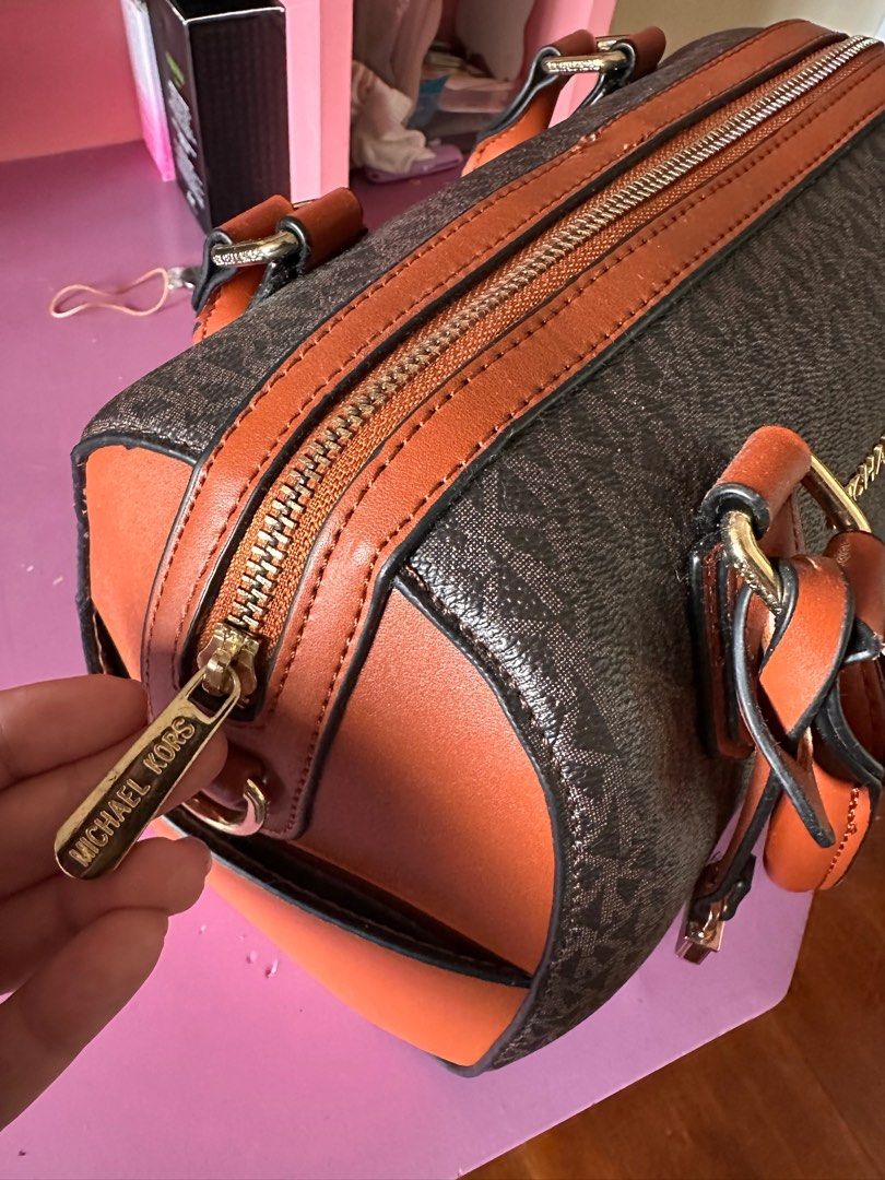 Michael Kors Brown Satchel Bag (Class A) (Category: Luxury Bags & Wallets) located in Tanza. Submitted by euniceericka (Listing ID 1414467046, Image 2). Description: - Michael Kors satchel bag (Class A) - Brown monogram pattern with tan accents - Top zipper closure - Dual top handles - Interior slip pocket - Comes with original tags - Gold-toned hardware - Branded zipper pull - Never been used RFS: Decluttering.