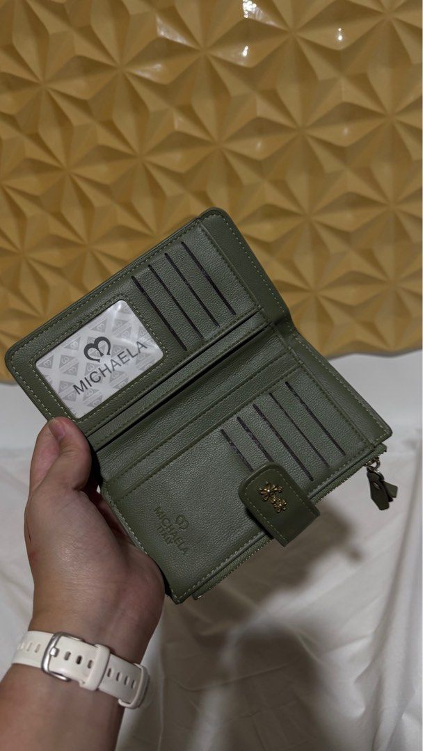 Michaela Wallet - Olive Green (Category: Wallets & Card holders) located in Makati City. Submitted by severusss (Listing ID 1414548749, Image 3). Description: - Olive green Michaela wallet - Multiple card slots - Clear ID window - Zippered compartment - Snap closure - Decorative floral accent - Leather-like material Rfs: stock.