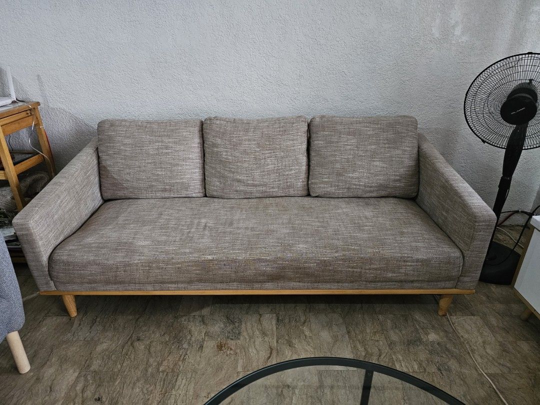 Minimalist 3-Seater Sofa Wooden (Category: Sofas) located in Muntinlupa City. Submitted by janelie (Listing ID 1414524558, Image 1). Description: Selling our 1-2 year old 3-seater fabric sofa with wooden base. Pillows have washable covers. Length: 190cm Width: 53cm Seating height: 37cm Condition: Excellent condition, like new. RFS: Changing the theme of our house Location: sucat paranaque Newly cleaned (vacuum+shampoo+ steam) last Feb 5, 2026:).