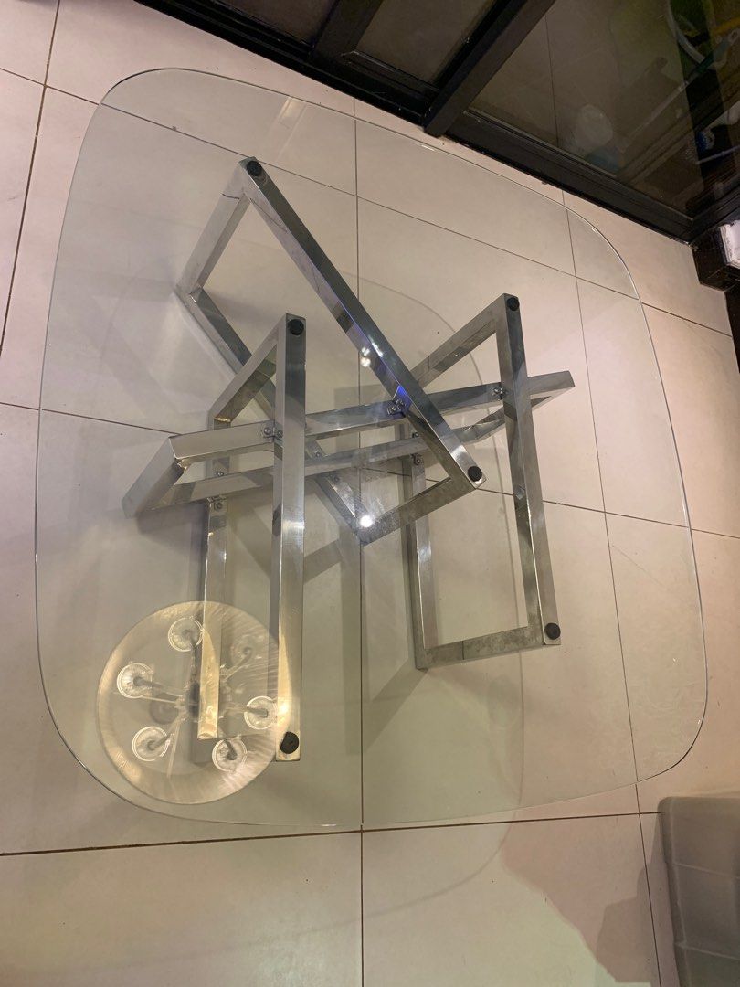 Modern Glass Coffee Table with Stainless Steel Frame (Category: Tables & Sets) located in Paranaque City. Submitted by trudetam (Listing ID 1414606942, Image 1). Description: - Stylish coffee table - Clear glass top - Unique stainless steel frame - Rectangular shape with rounded corners - Modern design - Great for living rooms.