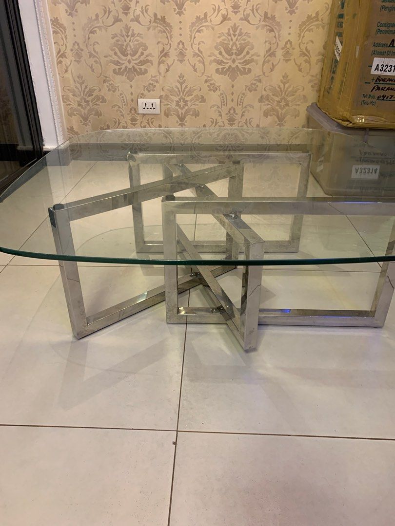 Modern Glass Coffee Table with Stainless Steel Frame (Category: Tables & Sets) located in Paranaque City. Submitted by trudetam (Listing ID 1414606942, Image 3). Description: - Stylish coffee table - Clear glass top - Unique stainless steel frame - Rectangular shape with rounded corners - Modern design - Great for living rooms.