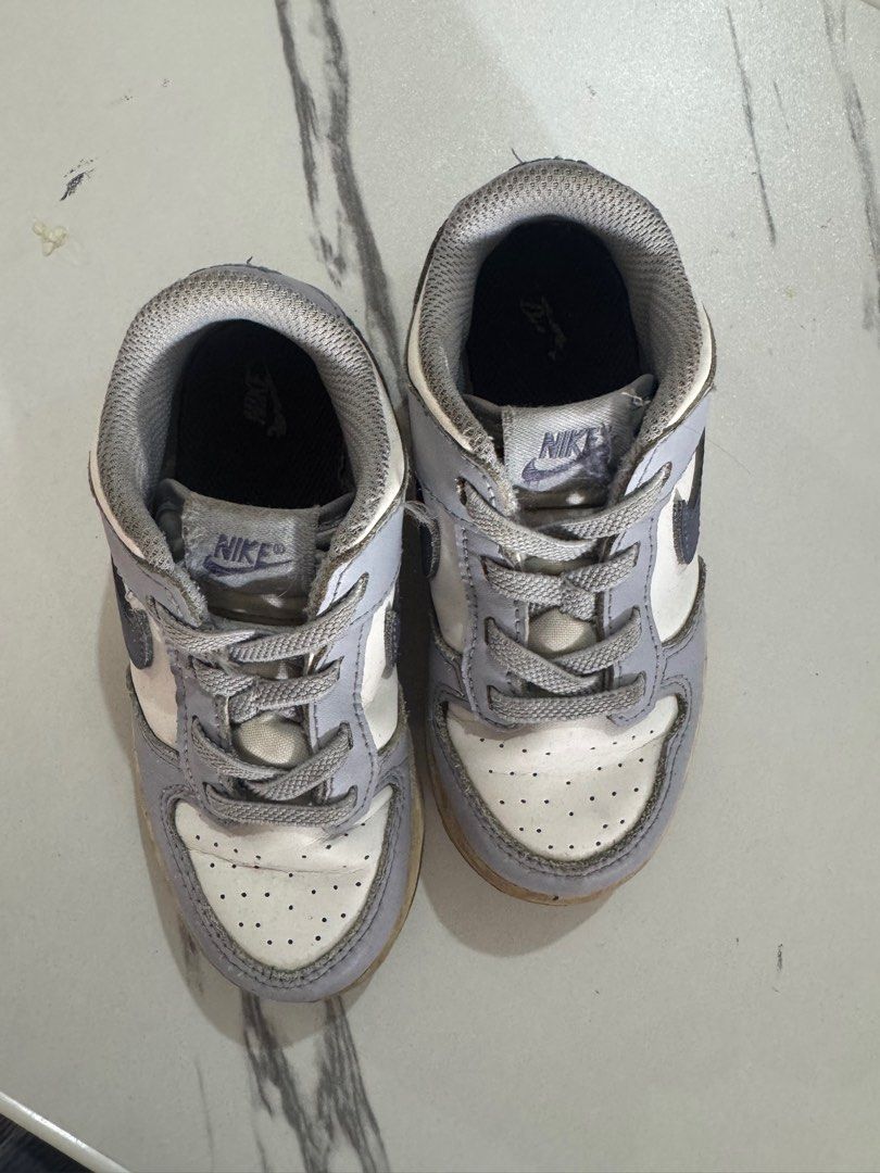 Nike Dunk Low Baby Shoes (Category: Babies & Kids Fashion) located in Quezon City. Submitted by aybidee (Listing ID 1414618882, Image 2). Description: - Nike Dunk Low baby shoes - Grey and white colorway - Nike logo detail - Signs of wear on soles - Laced up and ready to wear.