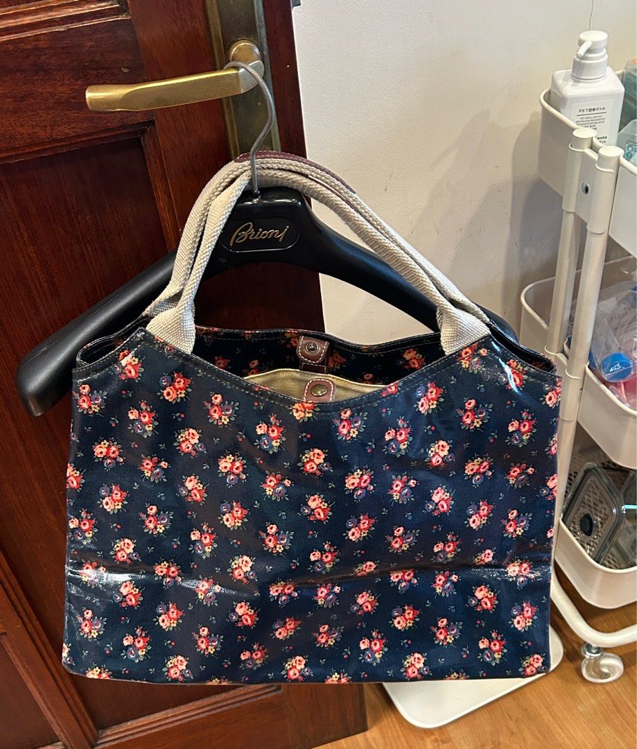 Original Cath Kidston Floral Handbag (Category: Tote Bags) located in Lubao. Submitted by iellahs (Listing ID 1414570448, Image 2). Description: - Cath Kidston floral handbag - Two front pockets - Secure zip closure - Interior zip pocket - Canvas lining - Cream-colored handles - Minor interior stains - Includes washing instruction tag -with stain inside but you can wash it.