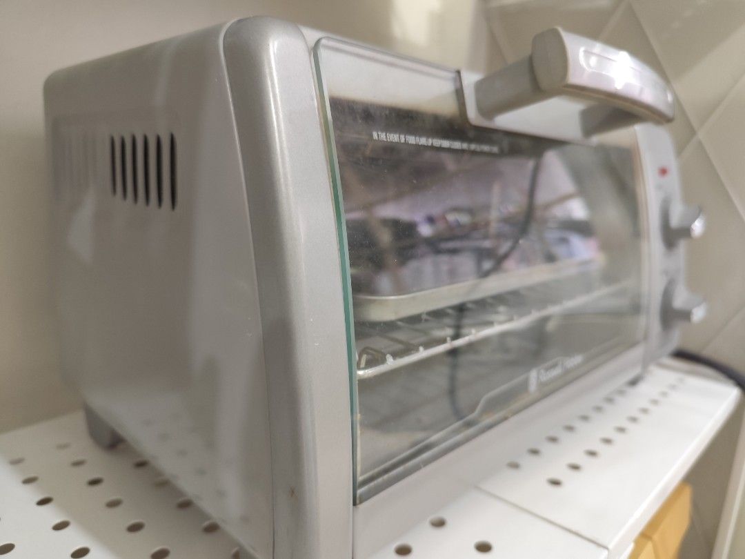 Oven Toaster (Category: Ovens & Toasters) located in Manila. Submitted by pctiu (Listing ID 1414623184, Image 2). Description: - Silver Russell Hobbs toaster oven - Temperature and timer controls - Includes wire rack and baking tray - Glass door for easy viewing - Perfect for toasting, baking, and grilling - Compact size, ideal for small spaces.
