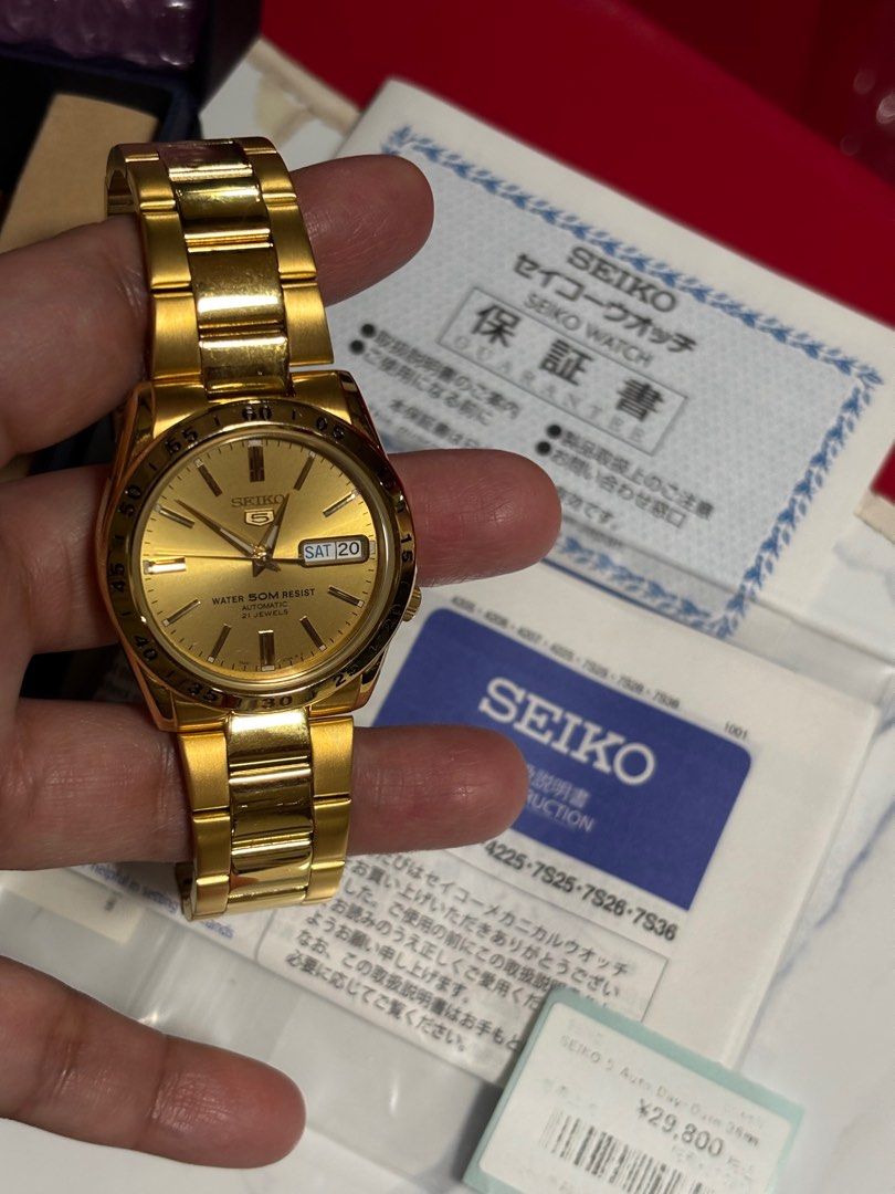 Seiko 5 Automatic Day-Date 36mm Gold Watch (Category: Women's Watches) located in Quezon City. Submitted by things.matter (Listing ID 1414589057, Image 1). Description: - Seiko 5 Automatic Watch - Gold-toned dial and bracelet - Day and date display - Transparent case back - Includes original box, papers, and tags - Marked "WATER 50M RESIST" and "21 JEWELS".