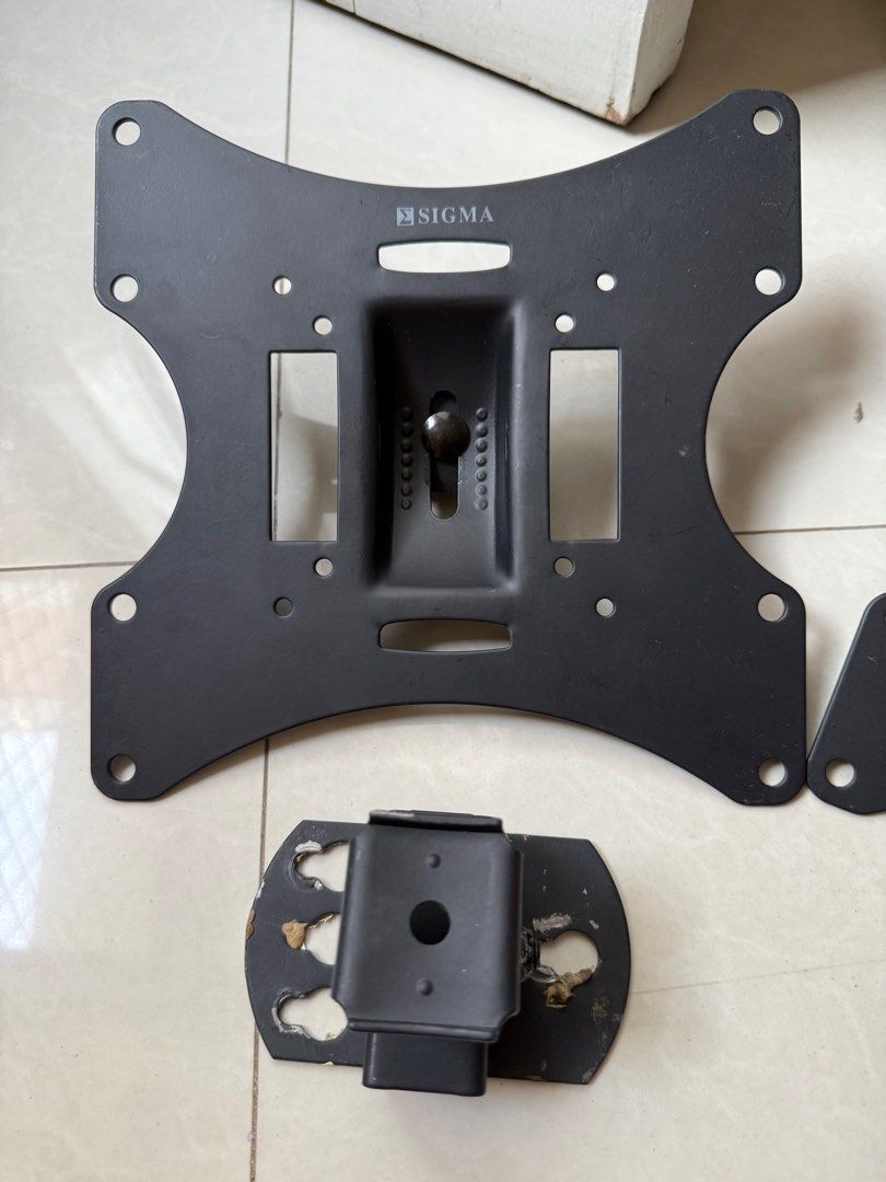 Sigma TV Wall Mount (set of 2) (Category: TV Parts & Accessories) located in Bacoor. Submitted by bbgey (Listing ID 1414461370, Image 2). Description: - Sigma TV wall mount - Includes two main mounting plates and two smaller brackets - Features ball joint for adjustable viewing angle - Sleek black color - Designed for standard VESA mounting patterns.