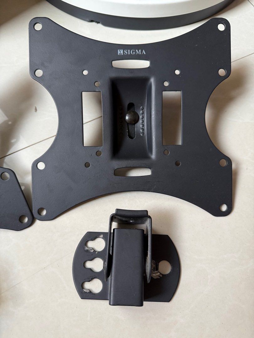 Sigma TV Wall Mount (set of 2) (Category: TV Parts & Accessories) located in Bacoor. Submitted by bbgey (Listing ID 1414461370, Image 3). Description: - Sigma TV wall mount - Includes two main mounting plates and two smaller brackets - Features ball joint for adjustable viewing angle - Sleek black color - Designed for standard VESA mounting patterns.