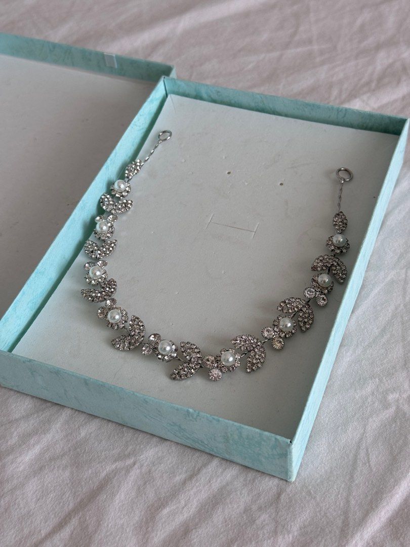Silver Pearl Headband Hair Accessory (Category: Hair Accessories) located in Quezon City. Submitted by dreamhues (Listing ID 1414495269, Image 2). Description: Silver Pearl Headband Hair Accessory → Never used, was just in storage → Original packaging, comes in a light blue-green gift box → Intricate design, ideal for special events.