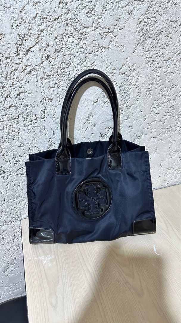 Authentic Tory Burch Ella Nylon Tote Bag Small (Category: Luxury Bags & Wallets) located in Manila. Submitted by pamsayat (Listing ID 1414584682, Image 2). Description: Size: Small 13 inches x 9.5 inches Condition: • Intact handle rubber linings • Clean interior, ready to use Issues: • Minimal scratches • Normal signs of use Reminders: • Last price is already posted and non-negotiable. • No return or exchange. All sales are final. Please ensure t