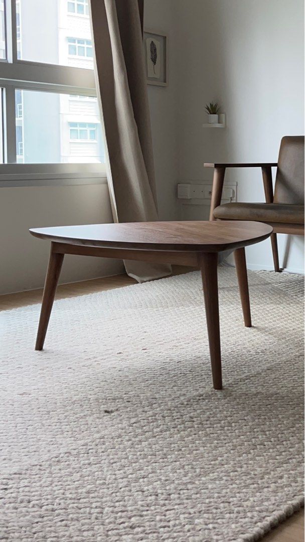 Triangular Solid Teak Coffee Table (Category: Tables & Sets) located in Singapore. Submitted by konicashoes (Listing ID 1414562257, Image 1). Description: Karpenter Vintage Tripod Teak Coffee Table An elegant designer coffee table by Karpenter, showcasing a distinctive triangular tripod silhouette. Expertly crafted from solid teak wood, the table features a rich, warm finish that highlights the natural grain and timeless beauty of the material. T