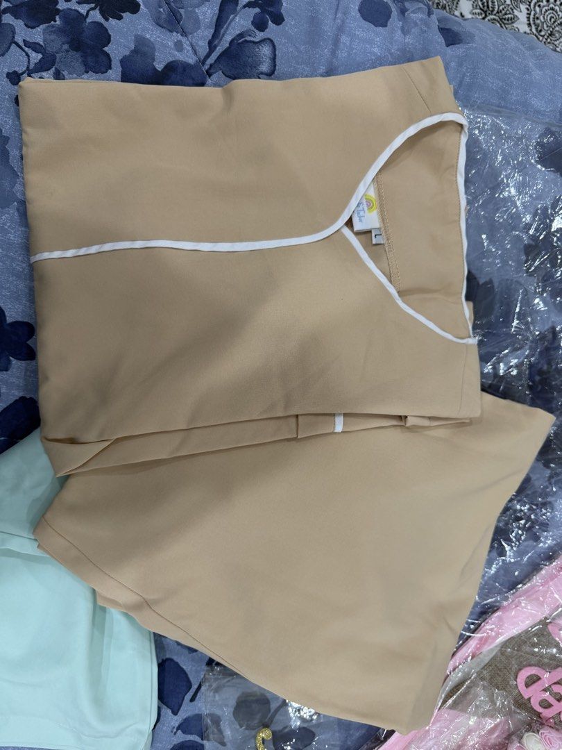 2 sets Lily & Tucker Beige Scrub Top Size L (Category: Blouses) located in Talisay. Submitted by itslucym (Listing ID 1465338033, Image 1). Description: - Brand: Lily & Tucker - Color: Beige with white V-neck trim - Size: Large - Condition: Brand new, still sealed in original plastic packaging - Fabric: Clean with a soft finish - Perfect comfortable addition to your work wardrobe - Two sets - Free extra green pants.