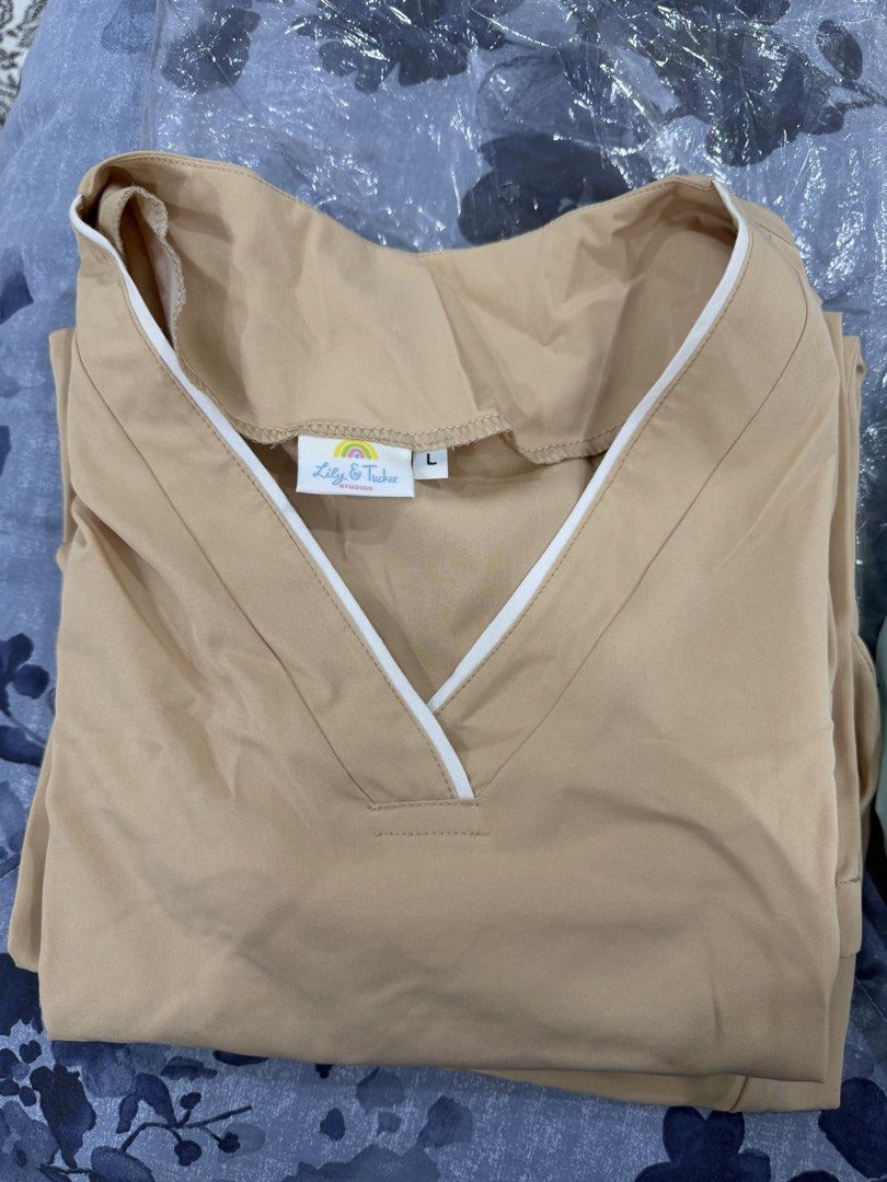 2 sets Lily & Tucker Beige Scrub Top Size L (Category: Blouses) located in Talisay. Submitted by itslucym (Listing ID 1465338033, Image 3). Description: - Brand: Lily & Tucker - Color: Beige with white V-neck trim - Size: Large - Condition: Brand new, still sealed in original plastic packaging - Fabric: Clean with a soft finish - Perfect comfortable addition to your work wardrobe - Two sets - Free extra green pants.