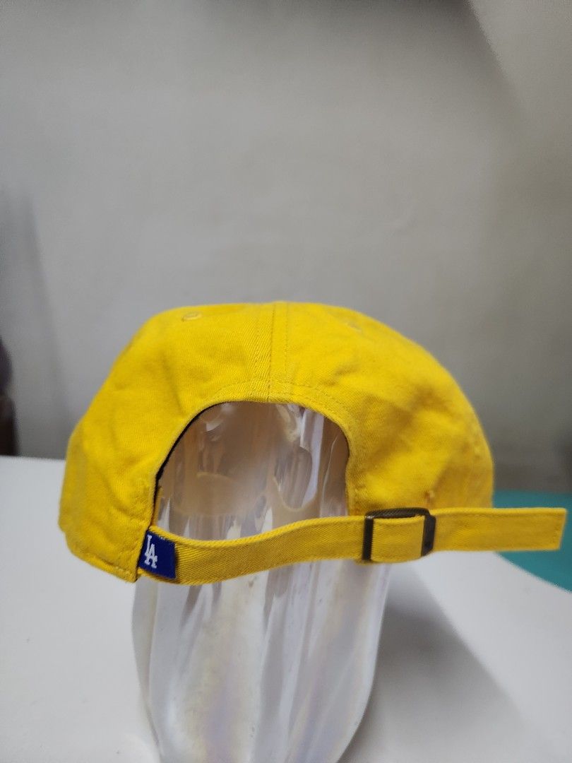 '47 Brand LA Dodgers Yellow Clean Up Adjustable Cap (Category: Caps & Hats) located in Quezon City. Submitted by amber___18 (Listing ID 1465347542, Image 3). Description: - Brand: '47 Clean Up - Team: LA Dodgers - Color: Bright yellow with white embroidered logo - Condition: Brand new, never worn, with original tags and brim sticker - Fit: Adjustable strap with metal slider.