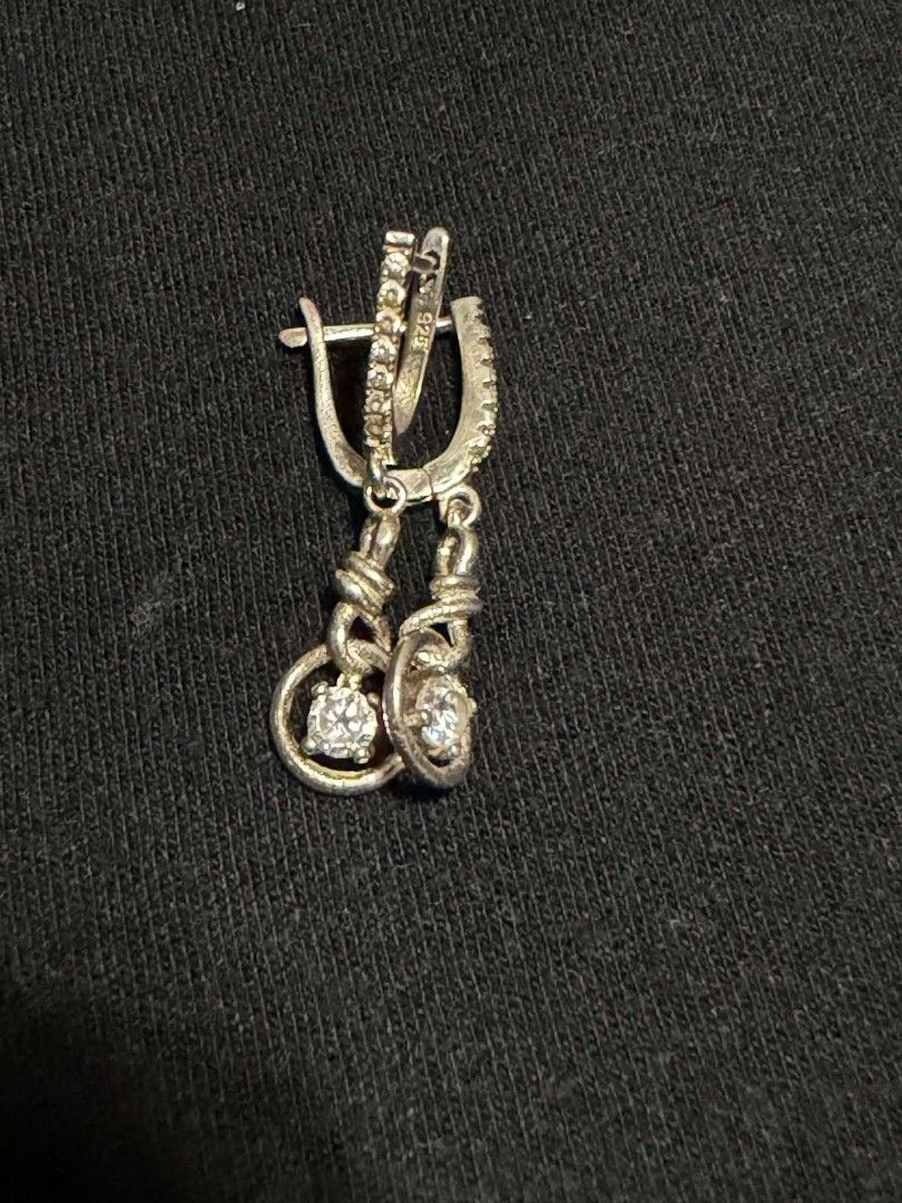 925 Silver Dangle Earrings with Crystals (Category: Earrings) located in Abucay. Submitted by thrifty.picked (Listing ID 1465357536, Image 2). Description: - Authentic 925 sterling silver (stamped on clasp) - Features sparkling pavé-set stones along the arch - Stunning solitaire crystal suspended inside a textured bottom ring - Secure lever-back closures for comfortable wear - Has a nice, premium weight and brilliant shine - Perfect for date nigh