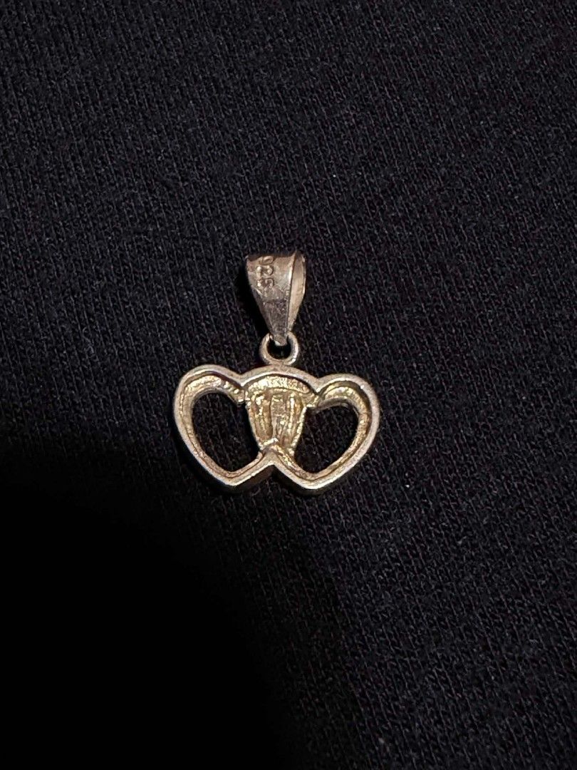 925 Silver Interlocking Double Heart Pendant (Category: Necklaces) located in Abucay. Submitted by thrifty.picked (Listing ID 1465359379, Image 2). Description: - Material: Genuine 925 sterling silver with official hallmark stamp - Design: Elegant interlocking double open hearts with a polished finish - Versatile: Small bail fits most standard necklace chains - Style: Simple, lightweight, and perfect for everyday wear - Ready to gift or add to yo