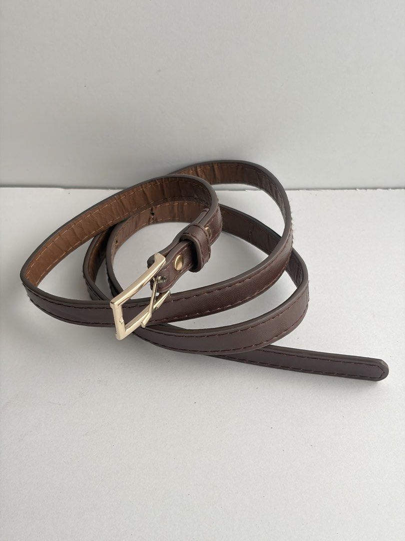 9. Slim Brown Leather Belt (Category: Belts) located in Quezon City. Submitted by wagwagan_ukay_blues (Listing ID 1465232590, Image 2). Description: From Japan In good condition Signs of usage Please manage your expectations Hole size - 26”-33” Width -.5” Overall-38” Novaliches Qc.