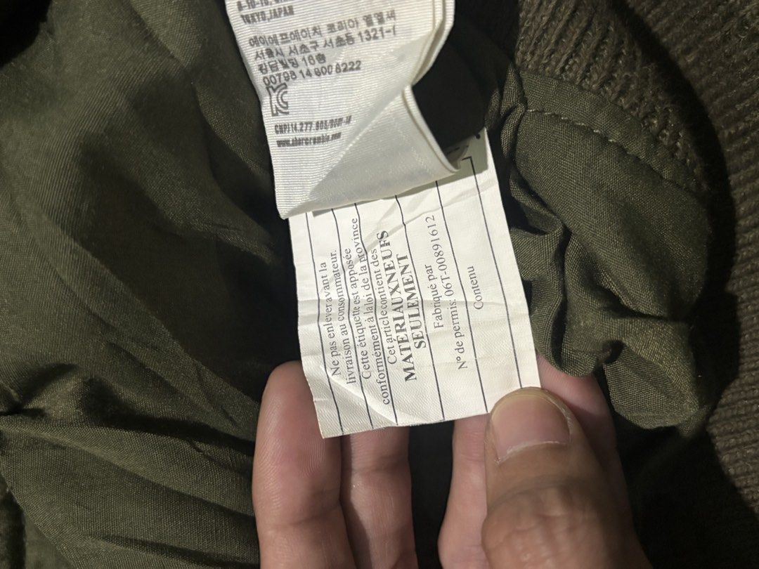 Abercrombie & Fitch Camo Bomber Jacket (Category: Coats, Jackets and Outerwear) located in Manila. Submitted by kyosei00 (Listing ID 1465314261, Image 3). Description: - Brand: Abercrombie & Fitch - Style: Zip-up bomber jacket - Color/Pattern: Green camouflage with white-striped ribbed collar, cuffs, and hem - Size: XXL (checked on interior tag) - Features: Full zip closure, two front welt pockets, and embroidered moose logo on the chest - Condit