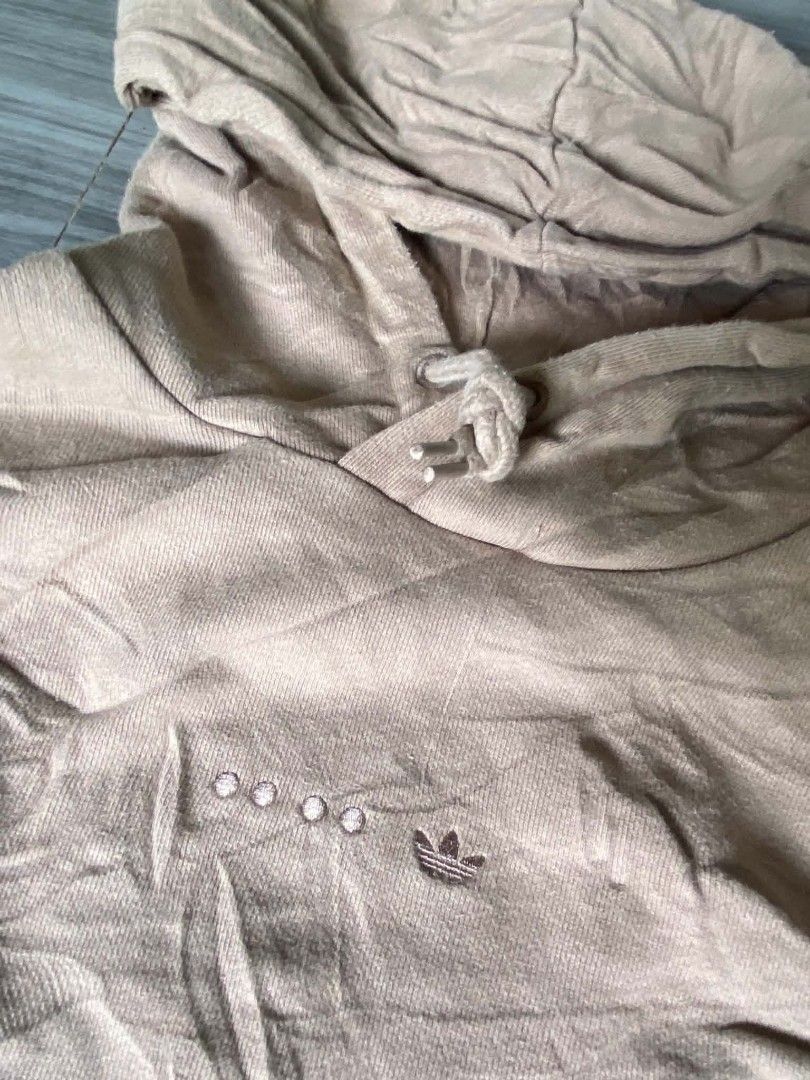 Adidas Beige Pullover Hoodie (Category: Hoodies) located in Zamboanga. Submitted by _branskiee.thrift16 (Listing ID 1465217943, Image 2). Description: - Brand: Adidas - Color: Beige - Material: Comfortable cotton - Features: Drawstring hood, front pouch pocket, ribbed cuffs and hem - Design: Classic three stripes on sleeves with embroidered Trefoil logo and chest accents - Condition: Great everyday piece.