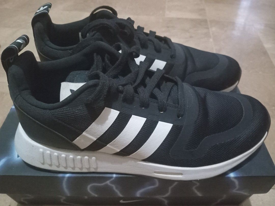 Adidas Black and White Sneakers (Category: Sneakers) located in Muntinlupa City. Submitted by mellowsmom (Listing ID 1465197367, Image 1). Description: - Brand: Adidas - Color: Classic Black and White - Upper: Breathable mesh material for all-day comfort - Design: Iconic three stripes with heel pull tab and branding - Sole: White chunky midsole with unique patterned detailing - Laces: Black laces - Condition: Brand new with box - Perfect for dail
