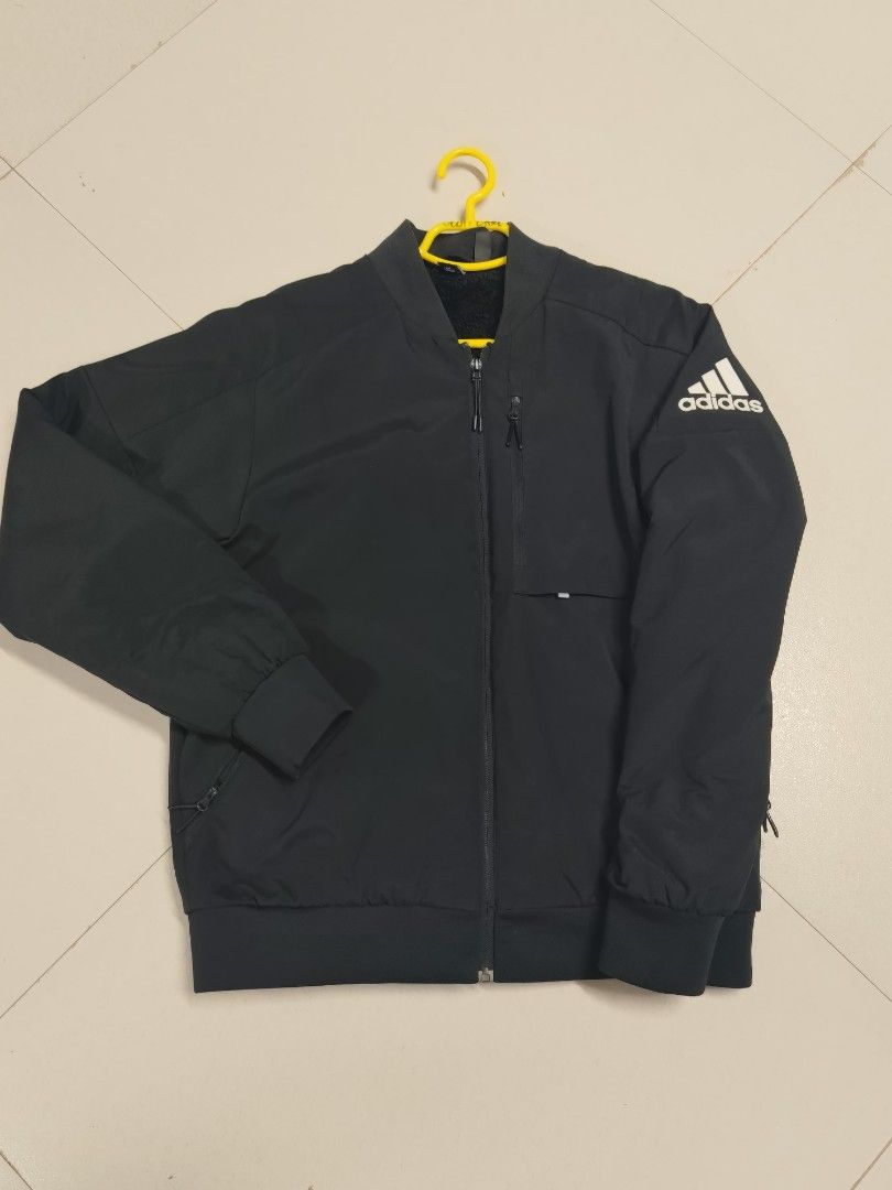 Adidas Black Bomber Jacket DX7192 (Category: Coats, Jackets and Outerwear) located in Abuyog. Submitted by scottcarl06 (Listing ID 1465305298, Image 2). Description: - Brand: Adidas - Style: Bomber jacket - Color: Black with white logo on left shoulder - Material: Soft fleece lining inside, made in China - Features: Full zip front, ribbed collar/cuffs/hem, zipped utility pocket on left chest - Product Code: DX7192 - Condition: Clean and well-kept