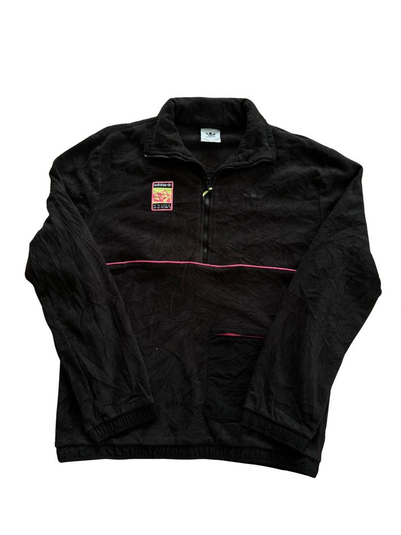 Adidas Black Half Zip Fleece Pullover (Category: Coats, Jackets and Outerwear) located in Teresa. Submitted by boanerjes (Listing ID 1465212436, Image 1). Description: - Brand: Adidas - Item: Black fleece pullover with half-zip neck - Details: Pink piping stripe across chest & mountain graphic patch on upper right - Pockets: Small front pocket on lower right with pink zipper trim - Branding: Tonal embroidered Adidas trefoil logo on upper left che