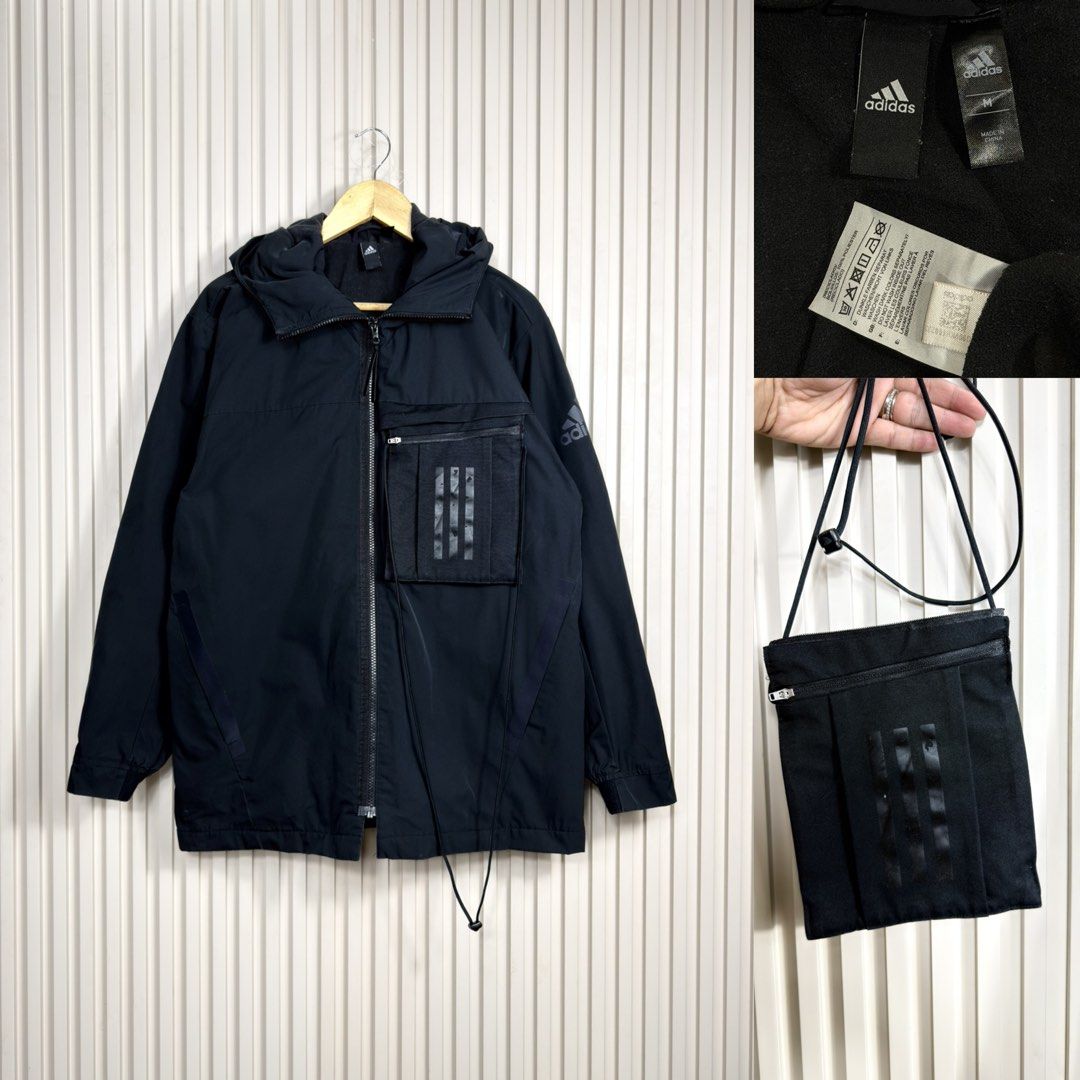 Adidas Black Hooded Jacket With Detachable Pouch (Category: Coats, Jackets and Outerwear) located in Pasig City. Submitted by trendapparelph (Listing ID 1465264975, Image 1). Description: - Brand: Adidas - Color: Black - Size: Medium (M) - Style: Full zip hooded jacket with ribbed cuffs and subtle sleeve branding - Special Feature: Includes a detachable matching cross-body pouch bag on the front pocket - Vibe: Versatile everyday layer with unique