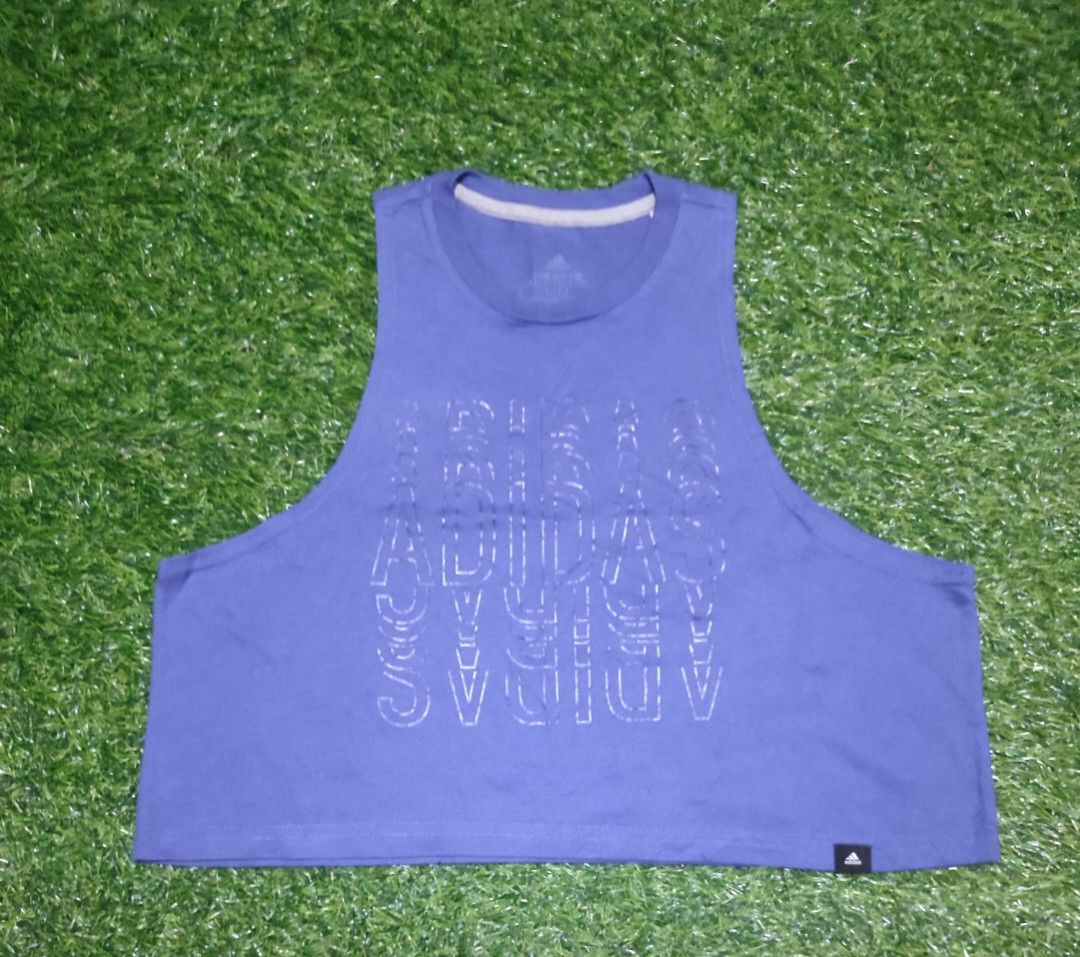 Adidas Blue Crop Tank Top (Category: Activewear) located in Cebu City. Submitted by deadjay84 (Listing ID 1465378750, Image 1). Description: - Brand: Adidas -Medium - Color: Blue with white outline logo and light grey collar trim - Style: Crop tank top with crew neck and dropped armholes - Material: Soft cotton jersey for maximum comfort - Details: Small black Adidas logo tag on bottom right hem - Ideal for: Gym workouts, runs, and casual streetw