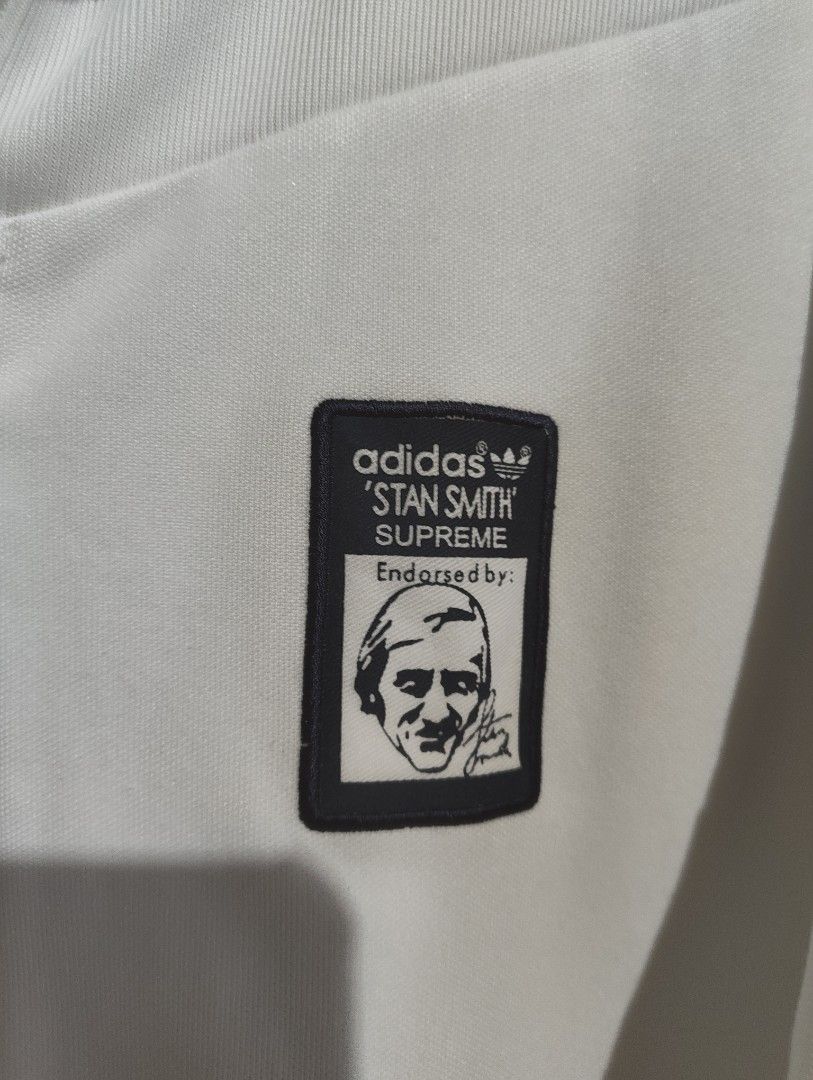 Adidas Stan Smith Supreme Track Jacket White Medium (Category: Coats, Jackets and Outerwear) located in Marikina City. Submitted by davidandrewjernie008 (Listing ID 1465263650, Image 3). Description: - Brand: Adidas Stan Smith x Supreme - Color: White with dark blue and white striped sleeves - Design: Special embroidered Stan Smith patch graphic on the left chest - Features: Full zip-up front, practical side zip pockets, and ribbed cuffs, collar,