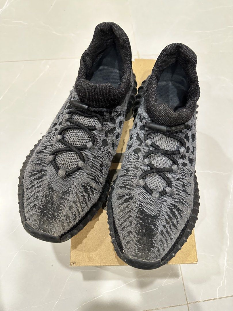 Adidas Yeezy Boost 350 V2 CMPCT Slate Carbon (Category: Sneakers) located in Talisay. Submitted by itslucym (Listing ID 1465342719, Image 3). Description: - Brand: Adidas Yeezy Boost 350 V2 CMPCT - Colorway: Slate Carbon (Grey/Black) - Features: Knit upper, bungee speed lacing, and Boost midsole cushioning - Inclusion: Original shoe box included - Condition: Moderate wear on outsoles and upper knit; still has plenty of life left for daily wear - 