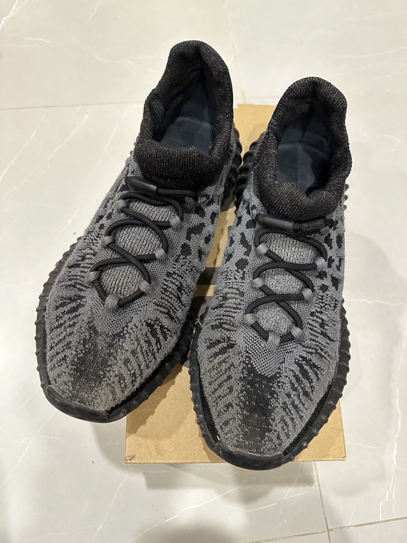 Adidas Yeezy Boost 350 V2 CMPCT Slate Carbon (Category: Sneakers) located in Talisay. Submitted by itslucym (Listing ID 1465342719, Image 1). Description: - Brand: Adidas Yeezy Boost 350 V2 CMPCT - Colorway: Slate Carbon (Grey/Black) - Features: Knit upper, bungee speed lacing, and Boost midsole cushioning - Inclusion: Original shoe box included - Condition: Moderate wear on outsoles and upper knit; still has plenty of life left for daily wear - 