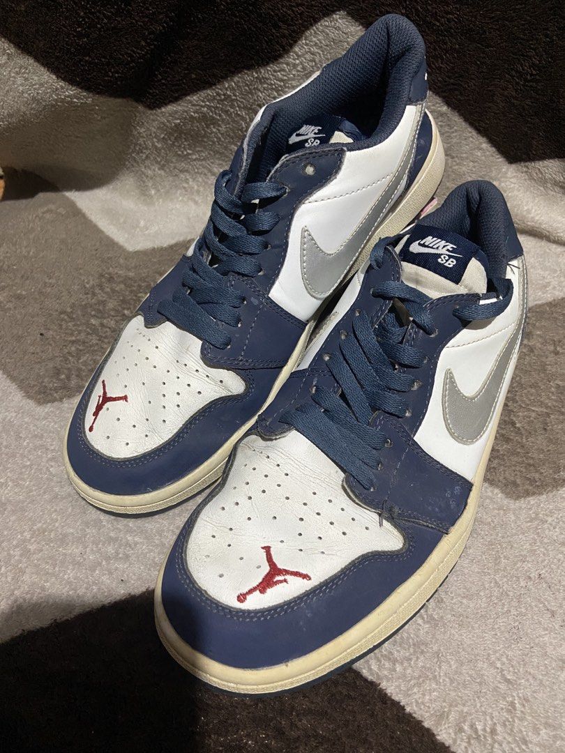 Air Jordan 1 Low Midnight Navy Silver (Category: Sneakers) located in Manila. Submitted by kiyanna.preloved (Listing ID 1465362036, Image 1). Description: - Model: Navy blue and white leather low-top sneakers - Accents: Silver swoosh, red embroidered Jumpman on toe box, white embroidered wings logo on heel - Details: Dark blue laces and matching outsoles - Condition: Regular wear, features noticeable creasing on the leather upper and yellowing on