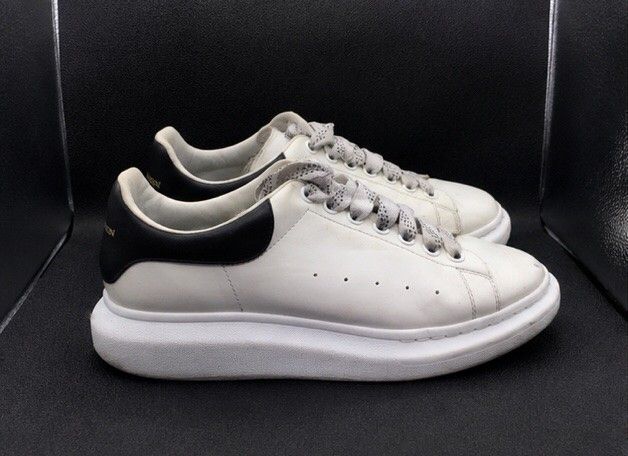 Alexander McQueen Elgard Sneaker White Black (Category: Sneakers) located in Batangas. Submitted by curatedluxxe88 (Listing ID 1465346786, Image 1). Description: - Brand: Alexander McQueen Elgard size 10 - Color: White leather with contrasting black heel counter and gold logo - Sole: Chunky rubber platform sole - Laces: Includes patterned grey laces - Condition: Normal signs of wear on uppers and soles; structure remains very solid - Style: Iconi